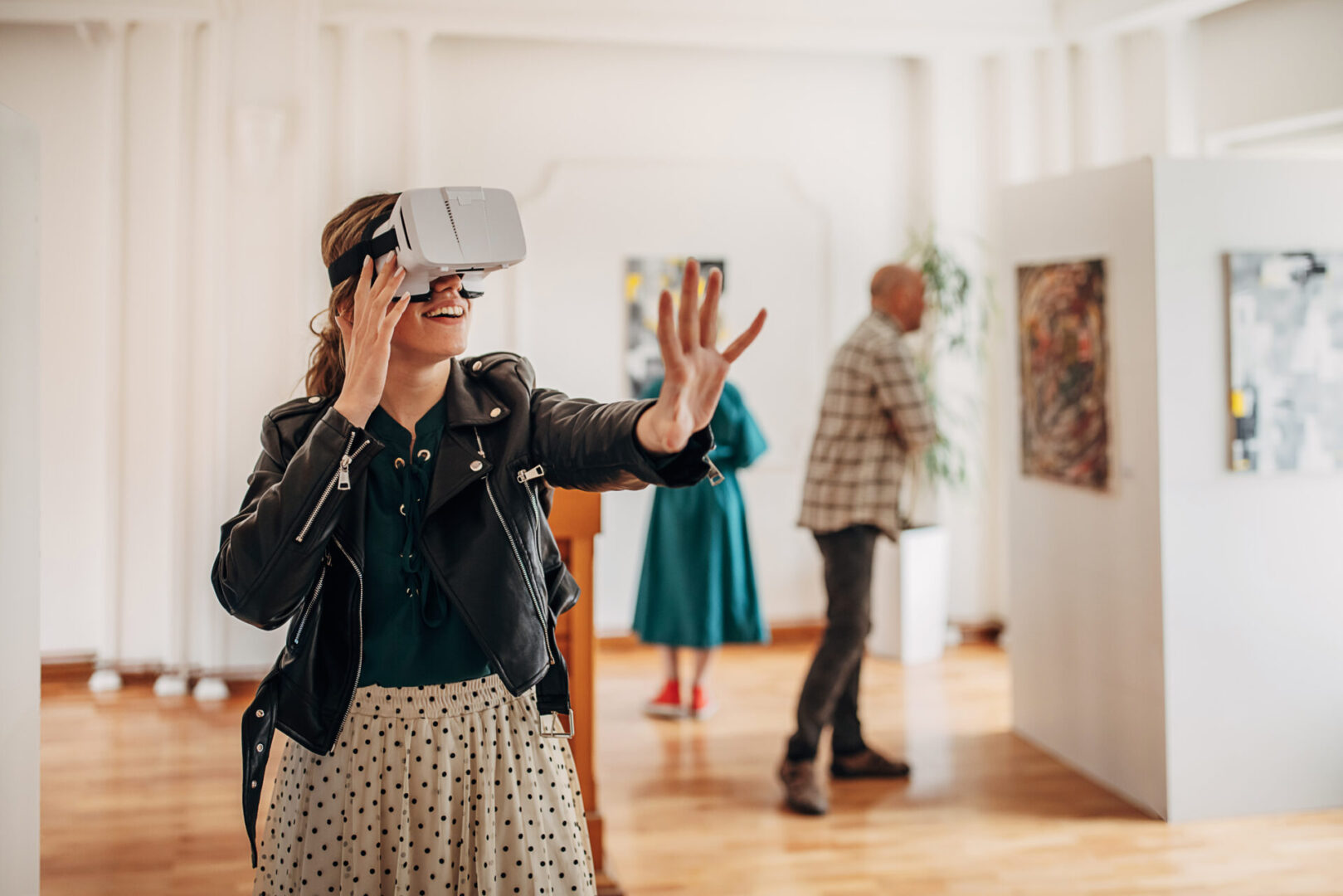 Person using VR headset in art gallery.